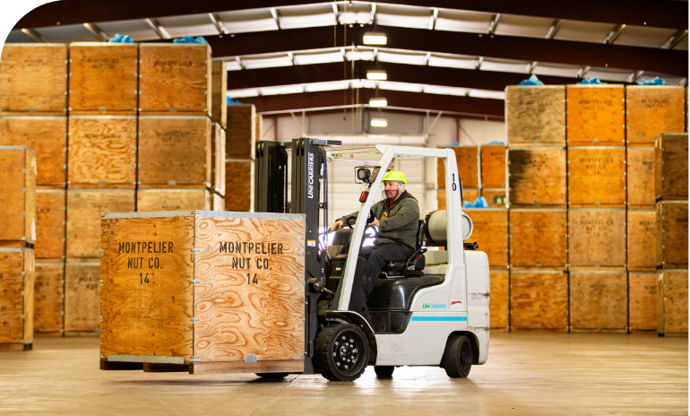 Forklift driver with almond crates at Montpelier Nut Co warehouse