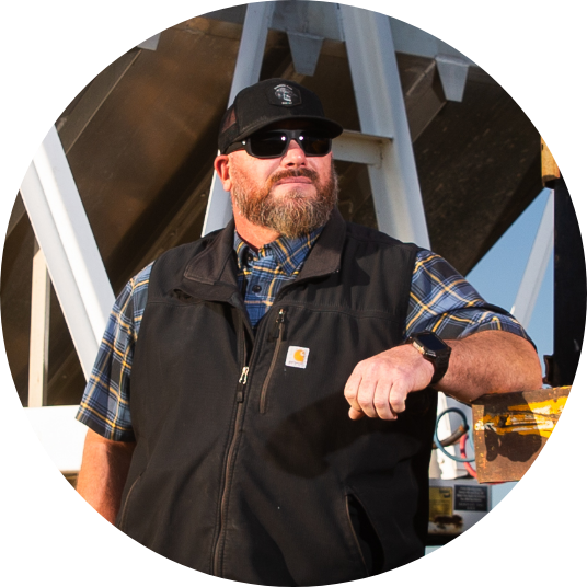 Man near almond processing equipment